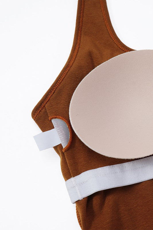 Brown bra with a beige adhesive pad on a white background