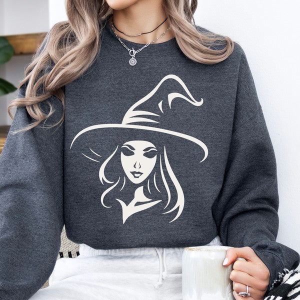 Person wearing a dark gray sweatshirt with a white witch graphic design.