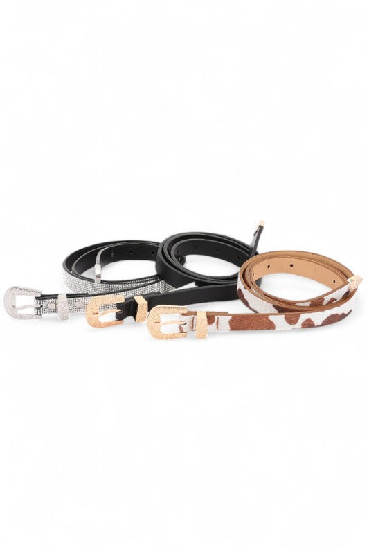 Three belts with different designs on a white background