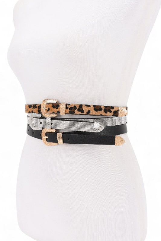 Mannequin wearing multiple belts with leopard print, black, and silver designs.