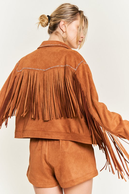 Person wearing a brown suede fringe jacket and shorts on a plain background