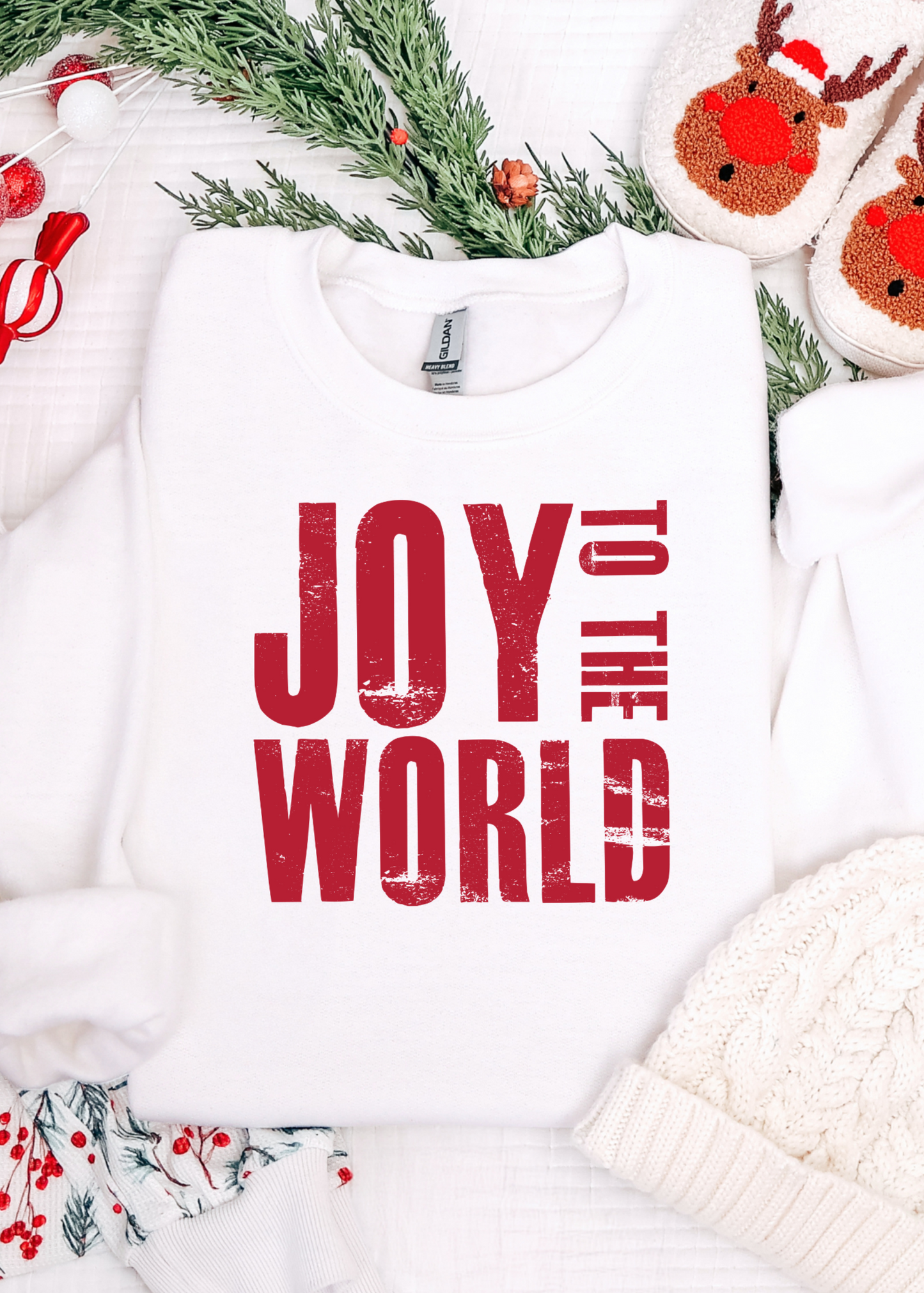 Holiday-themed outfit with 'Joy to the World' text, surrounded by Christmas decorations.