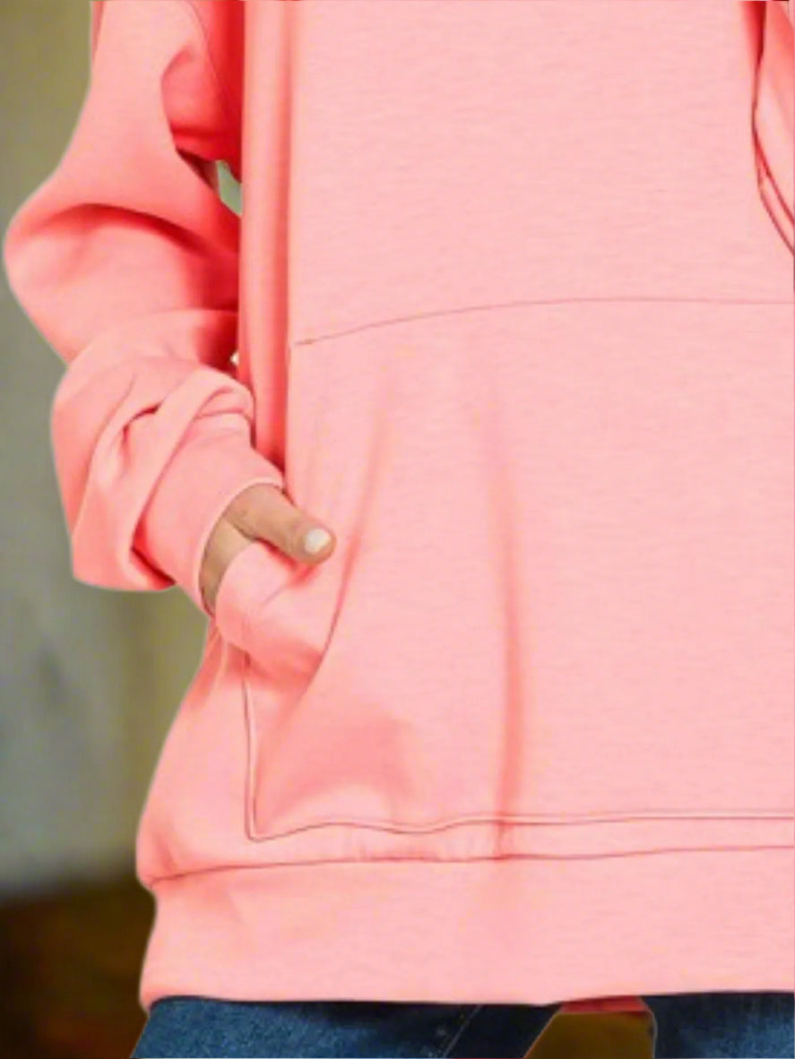 Close-up of a pink hoodie with a hand in the pocket on a white background
