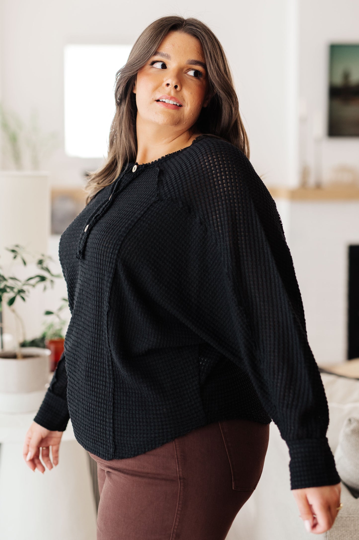 Woman wearing a black sweater in a home setting