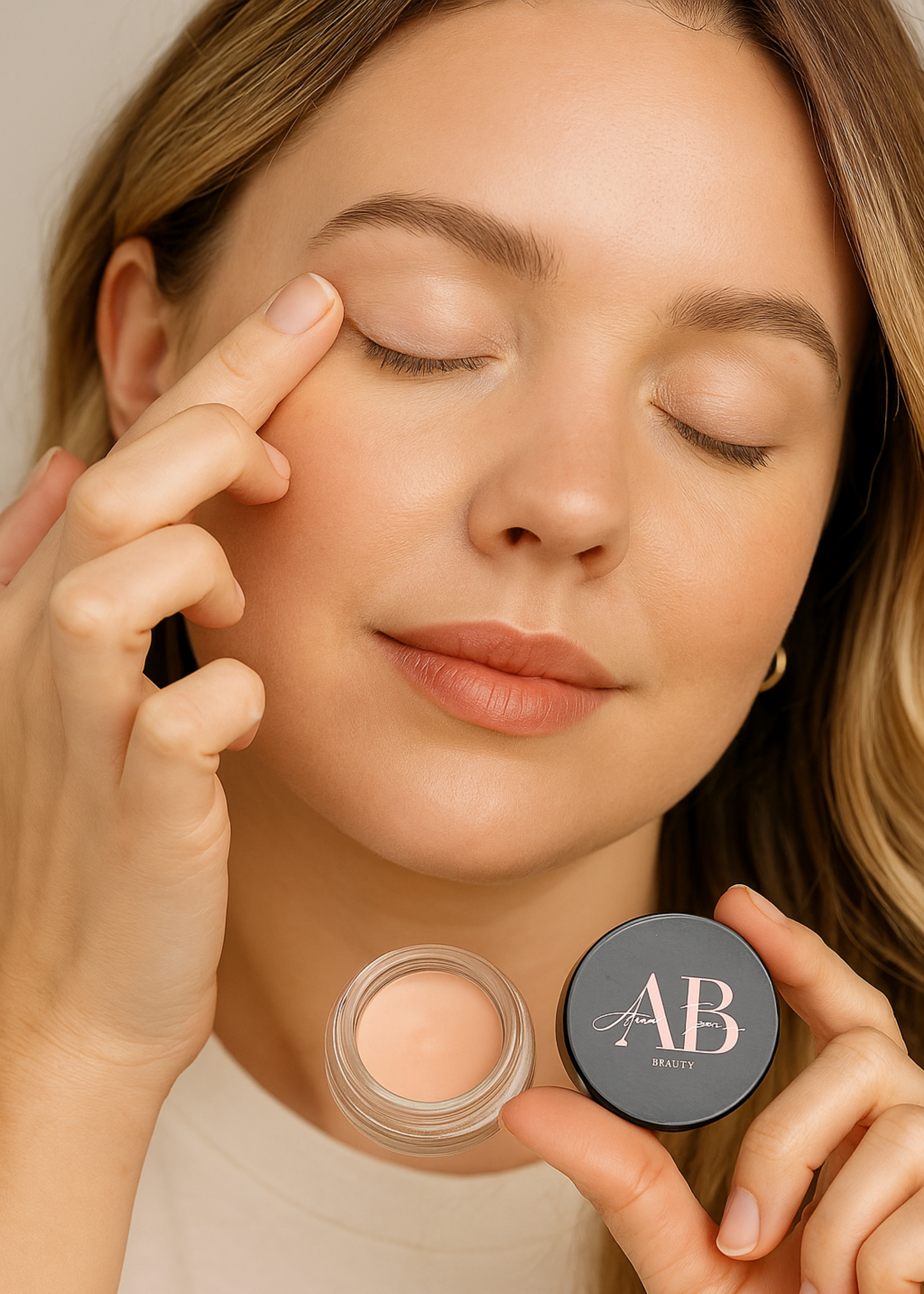 Woman applying cream to her face with a compact labeled 'AB' in the foreground.
