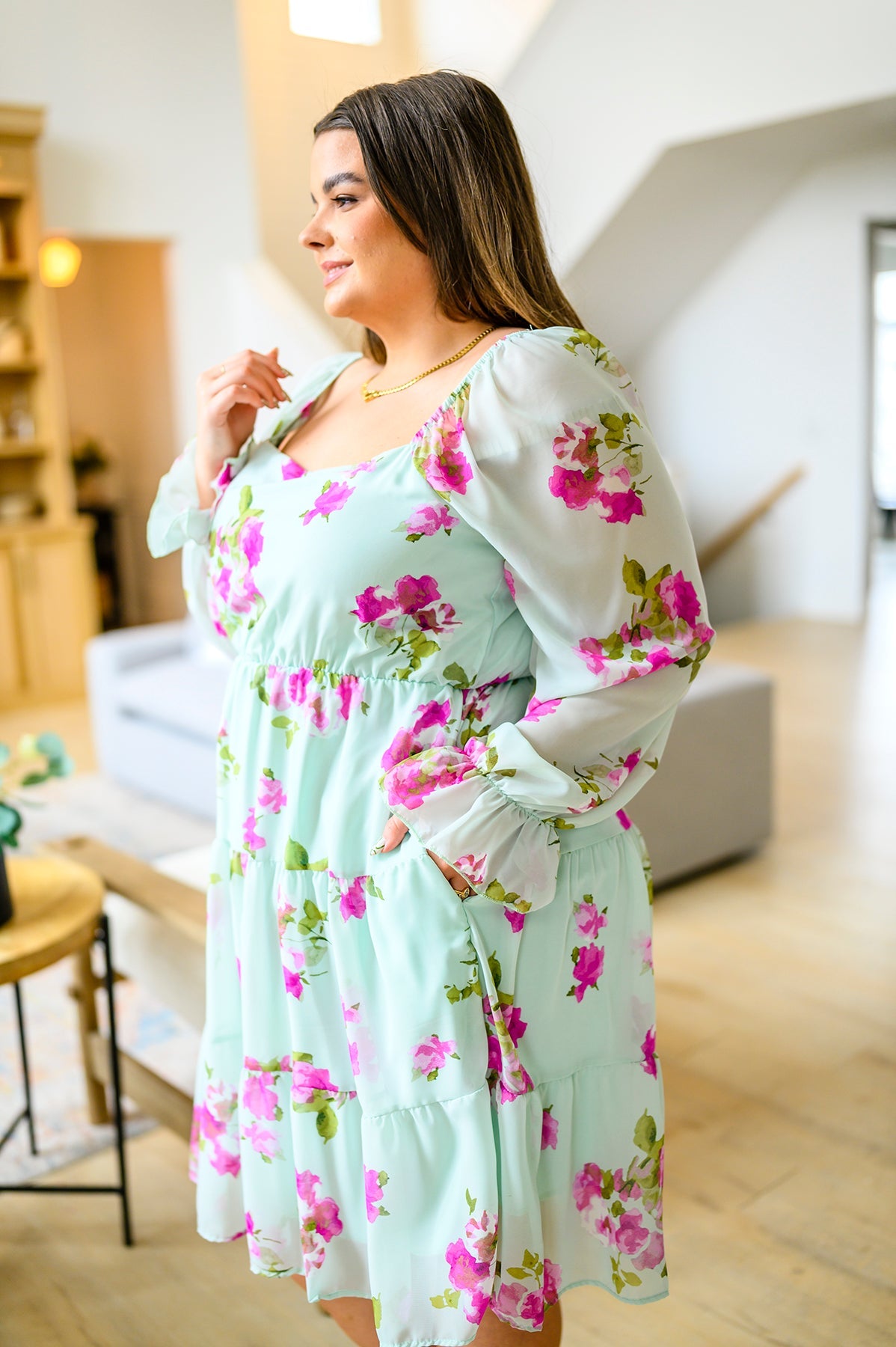 Woman wearing a floral dress in a modern living room