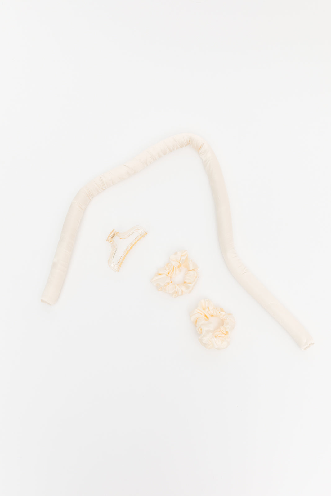 Close-up of a beige headband with floral designs on a light background