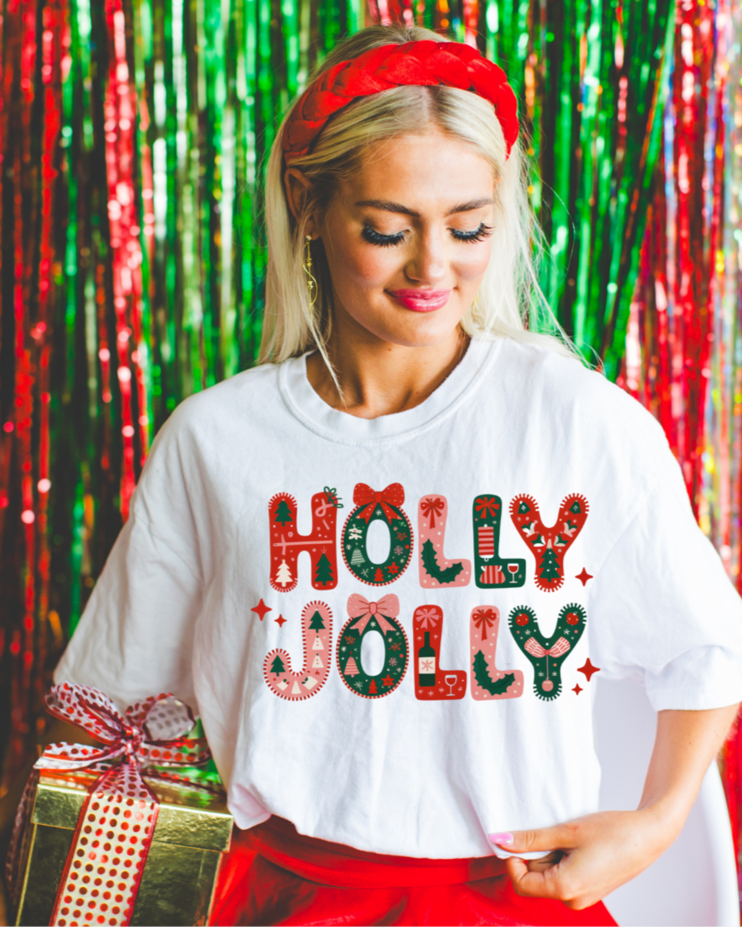 Woman wearing a 'Holly Jolly' shirt with a festive background