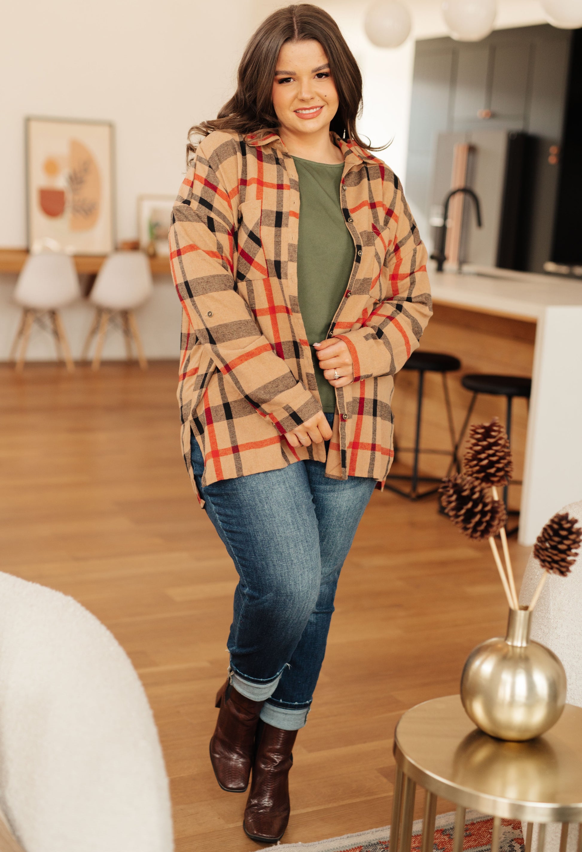 Woman wearing a plaid coat in a home setting