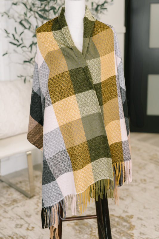 Plaid scarf on a mannequin with a blurred indoor background