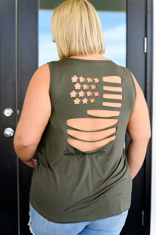 A woman wearing an olive green tank top with a laser cut flag design on the back, in a v-neckline cut.