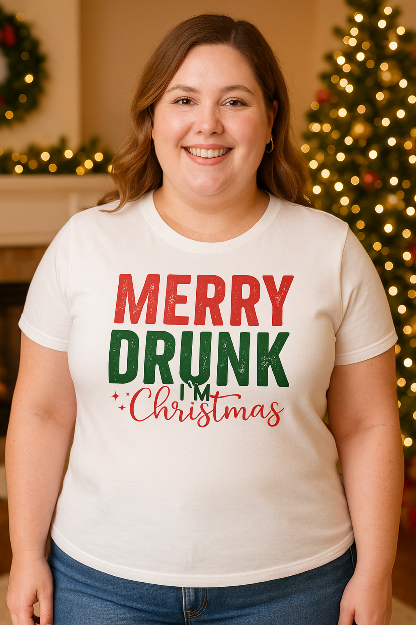 Person wearing a 'Merry Drunk I'm Christmas' shirt in front of a decorated Christmas tree.