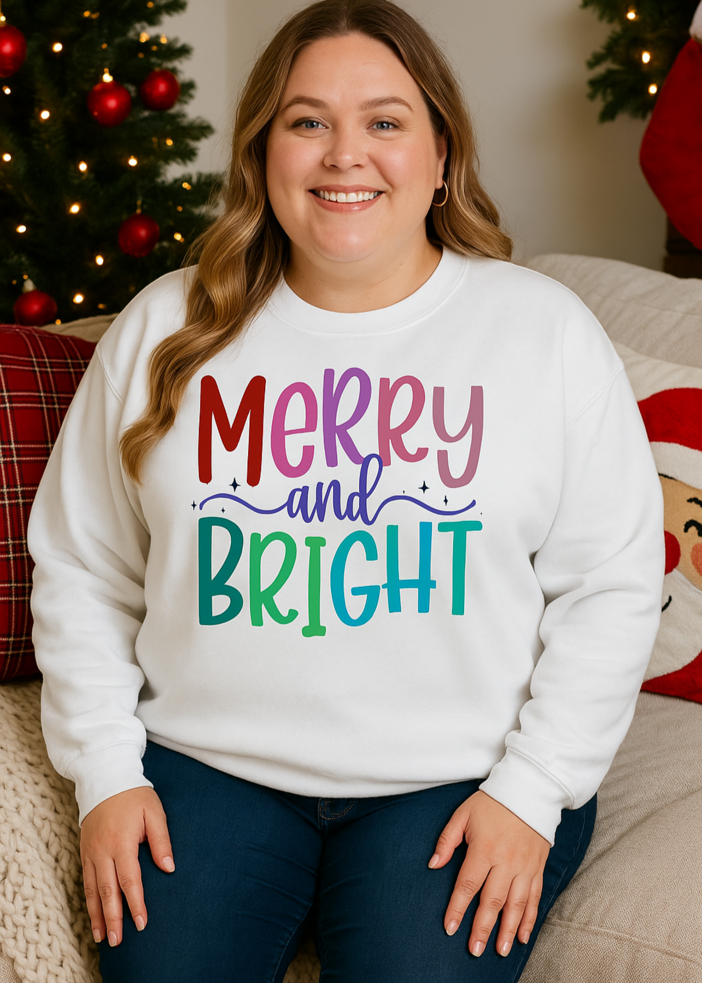 Person wearing a white sweatshirt with 'Merry and Bright' text in colorful letters, sitting in a festive setting.