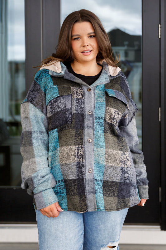 Person wearing a patchwork jacket with a blurred background