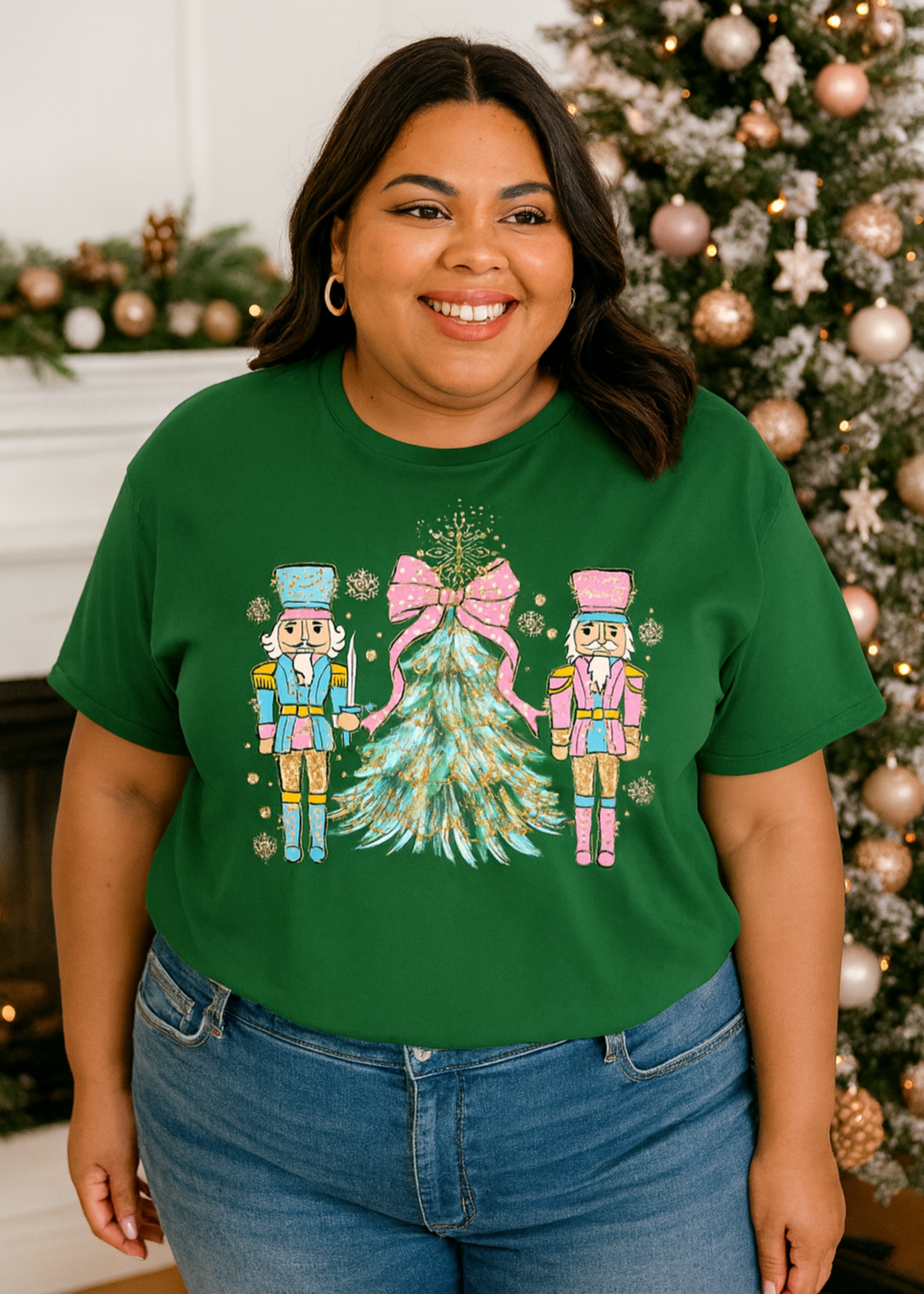 Person wearing a green t-shirt with a Christmas-themed design in front of a decorated tree.