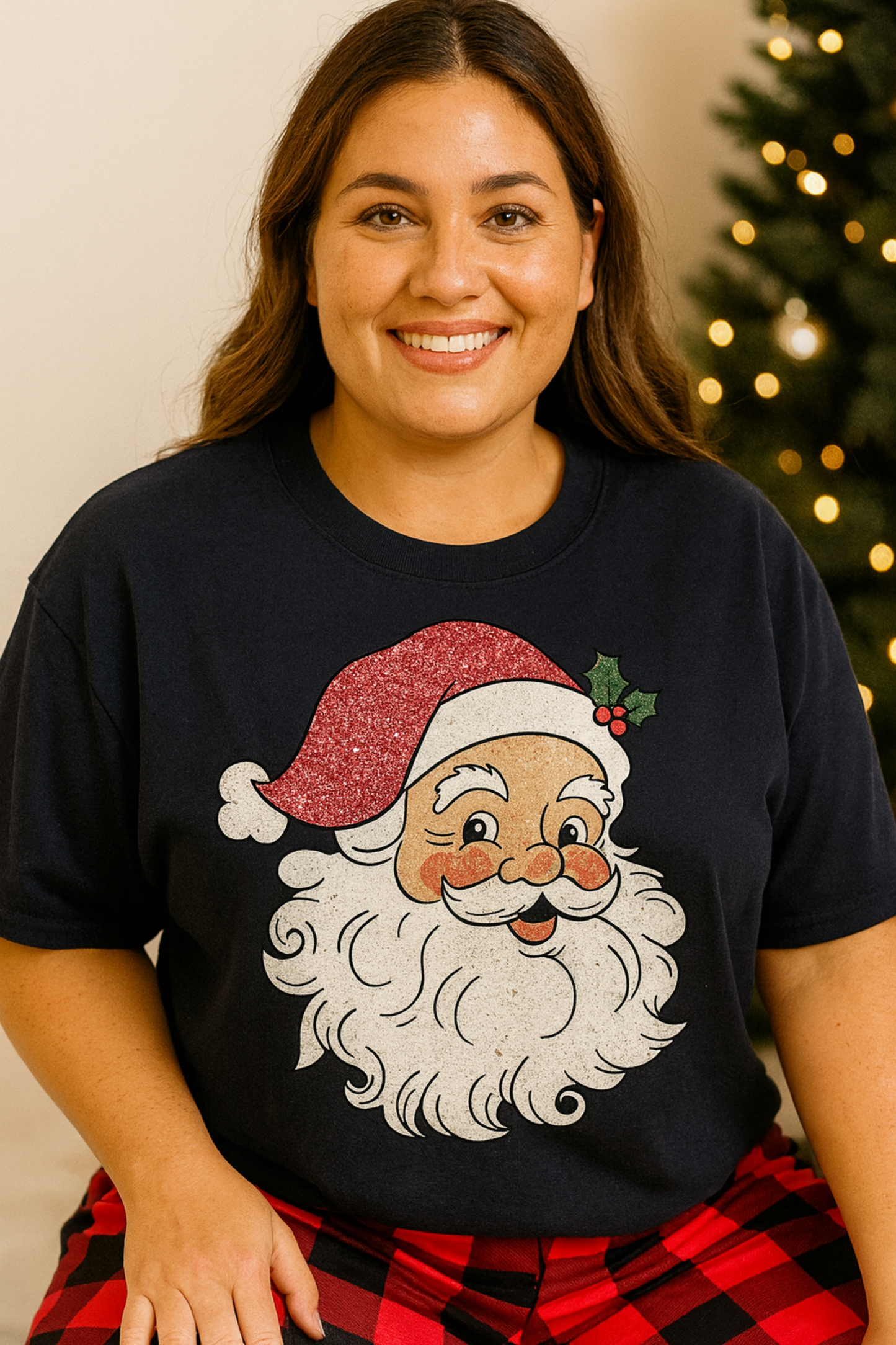 Person wearing a black t-shirt with a Santa Claus graphic in front of a Christmas tree.