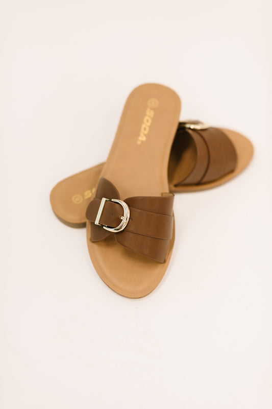 Brown sandals with a buckle on a white background