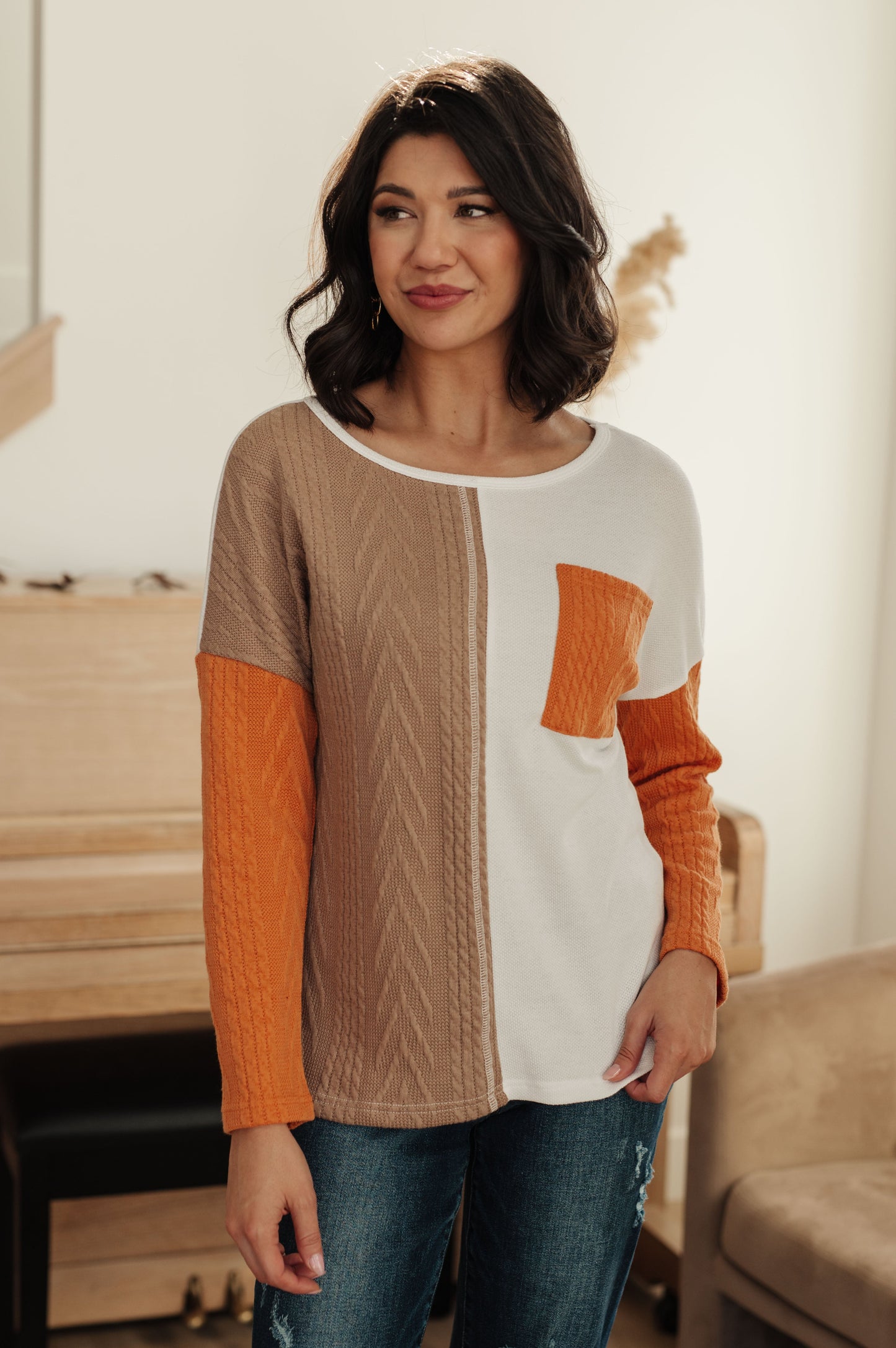 Woman wearing a colorful sweater in a casual setting