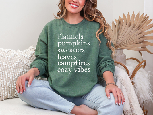Woman wearing a green sweatshirt with text, sitting on a couch with decorative elements.