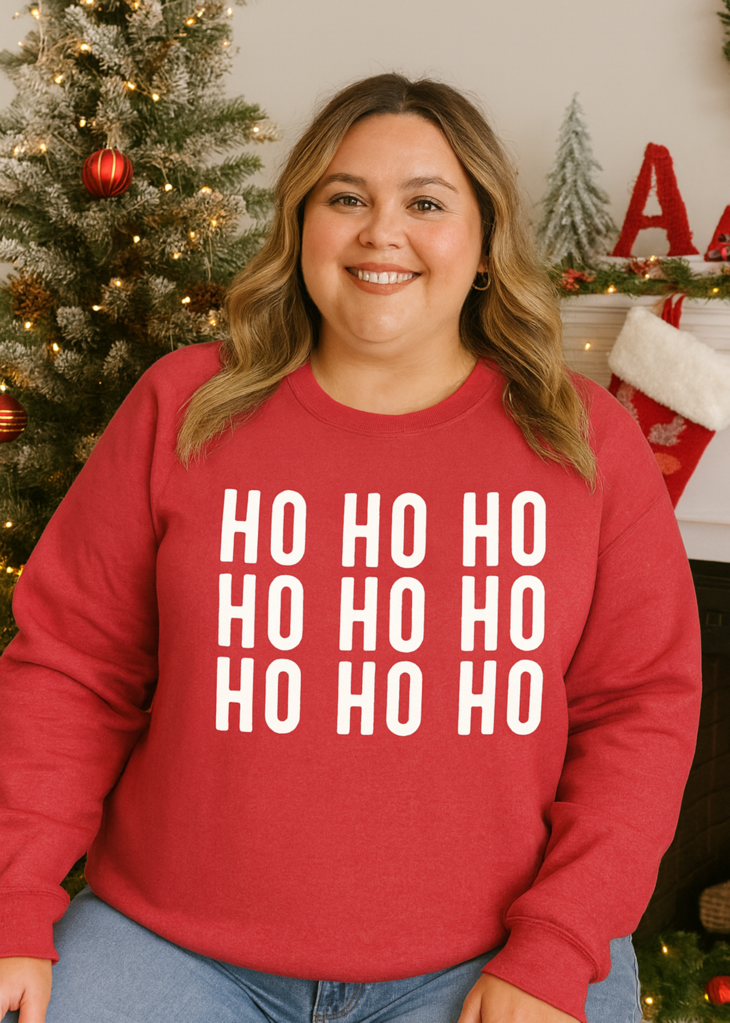 Person wearing a red 'HO HO HO' sweater in a festive setting with Christmas decorations.