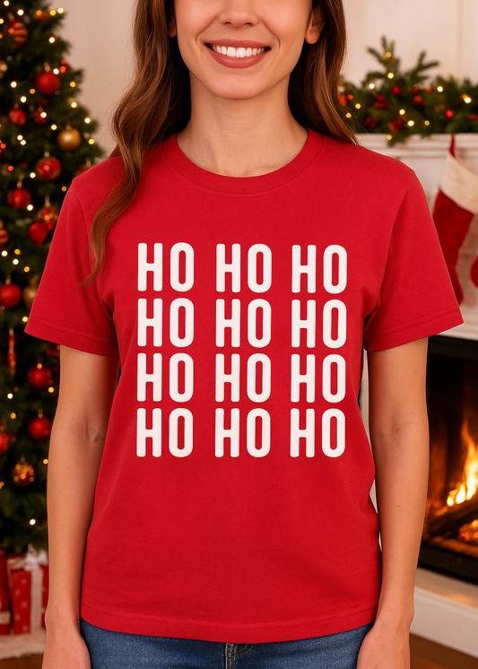 Person wearing a red t-shirt with 'HO HO HO' text in a festive setting.