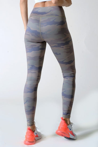 Camouflage leggings worn by a person on a white background