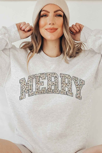 Person wearing a white sweatshirt with 'MERRY' printed in leopard print on a plain background