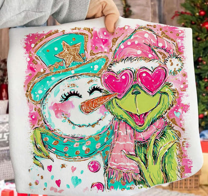 Colorful tote bag with a snowman and green character design, held by a person.