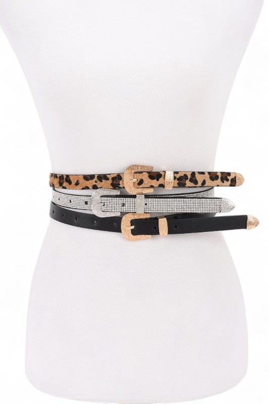 Set of three belts with different designs on a mannequin.