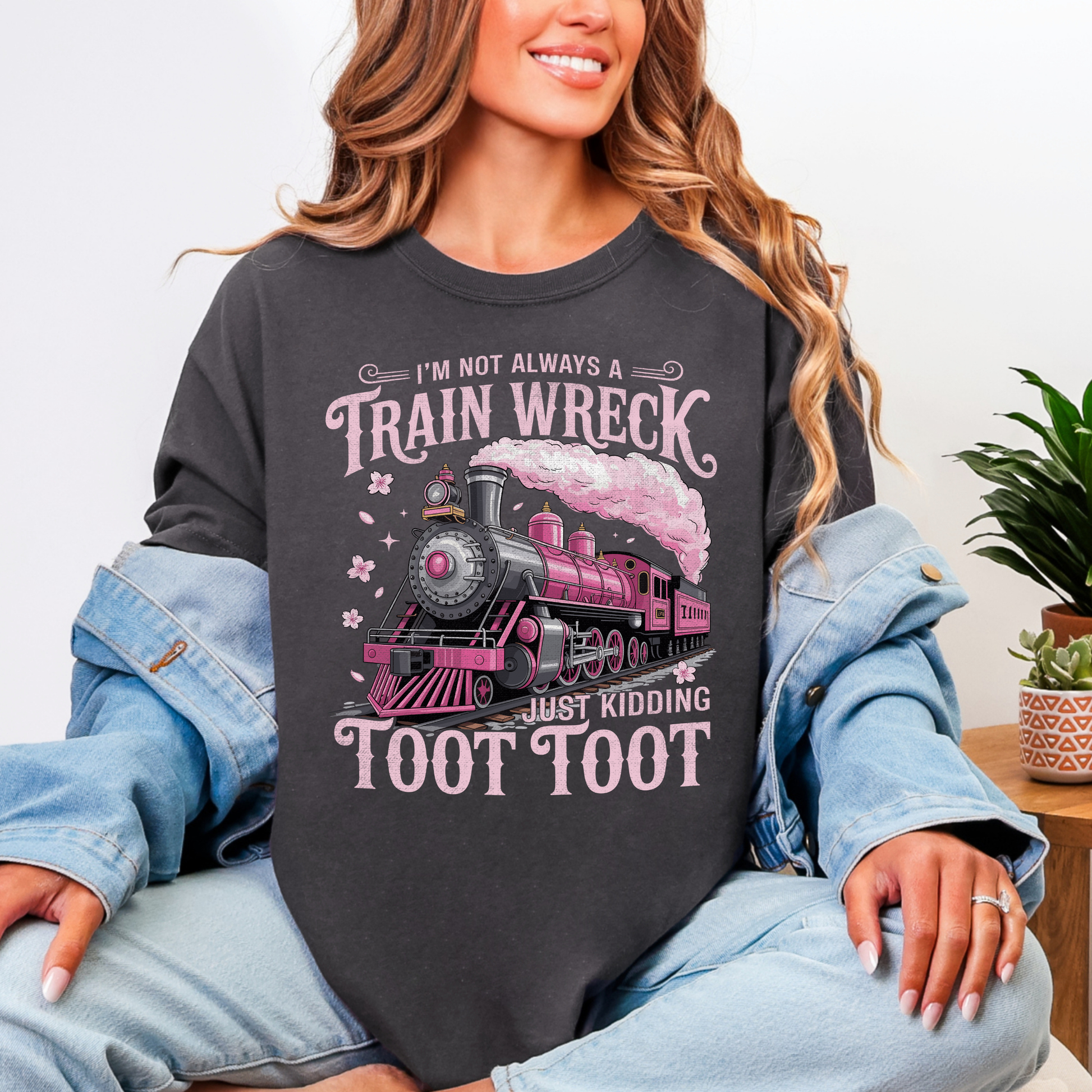 Person wearing a black sweatshirt with a train graphic and text.