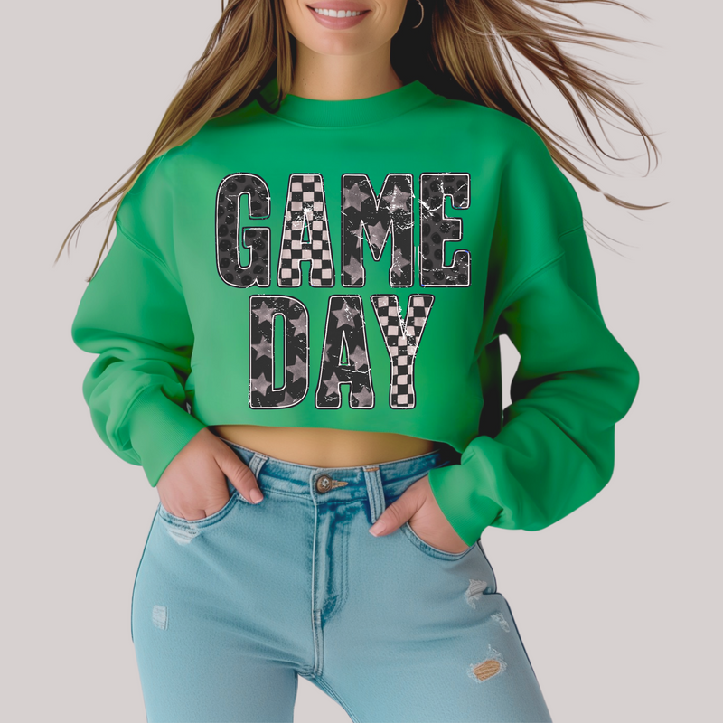 Person wearing a green 'GAME DAY' sweatshirt with checkered patterns.