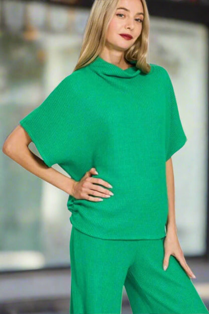 Woman wearing a green outfit on a white background