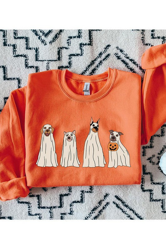 Orange sweatshirt with dog illustrations on a patterned rug