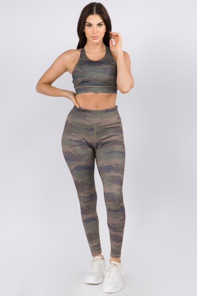 Woman wearing a camouflage sports bra and leggings set on a white background