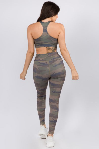 Woman wearing a camouflage sports bra and leggings set on a white background