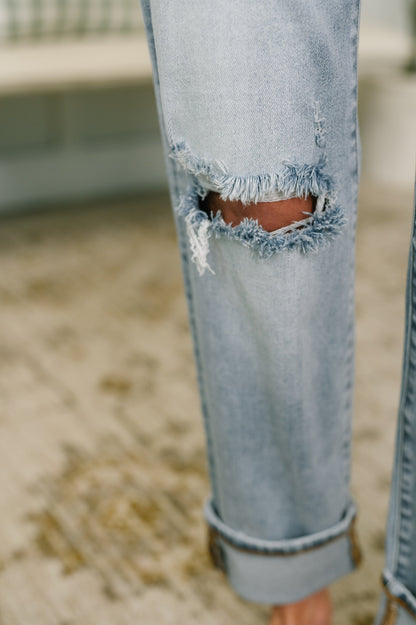 Close-up of light blue ripped jeans on a blurred background