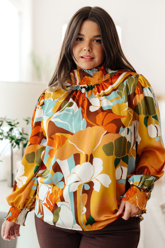 Woman wearing a colorful floral-patterned jacket indoors