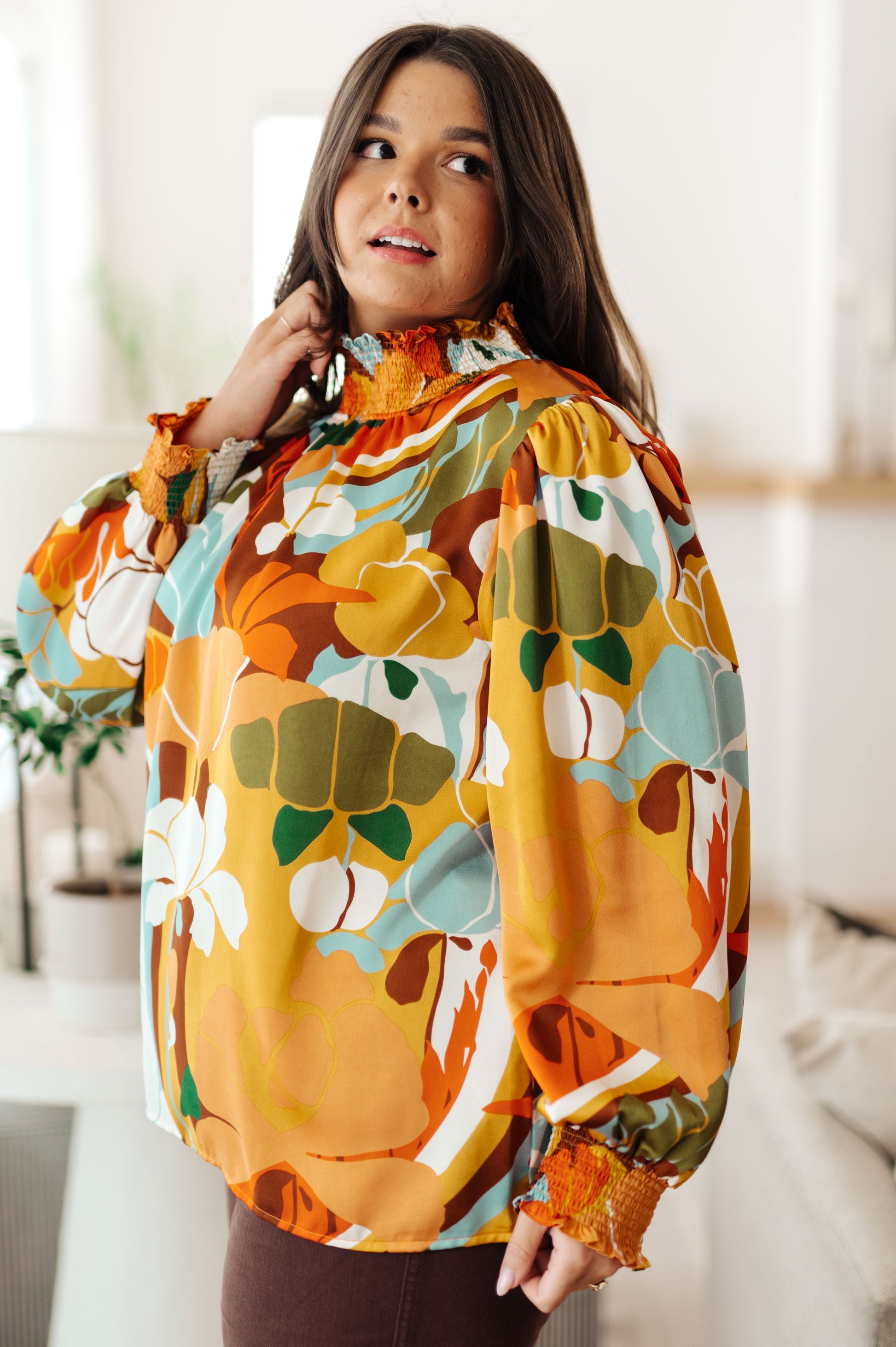 Woman wearing a colorful floral blouse indoors