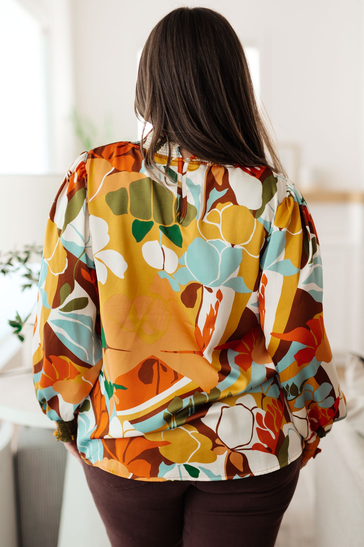Person wearing a colorful floral jacket indoors