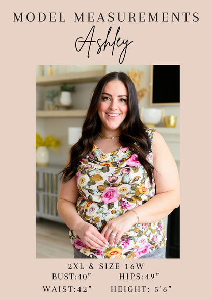 Woman wearing a floral top with model measurements displayed