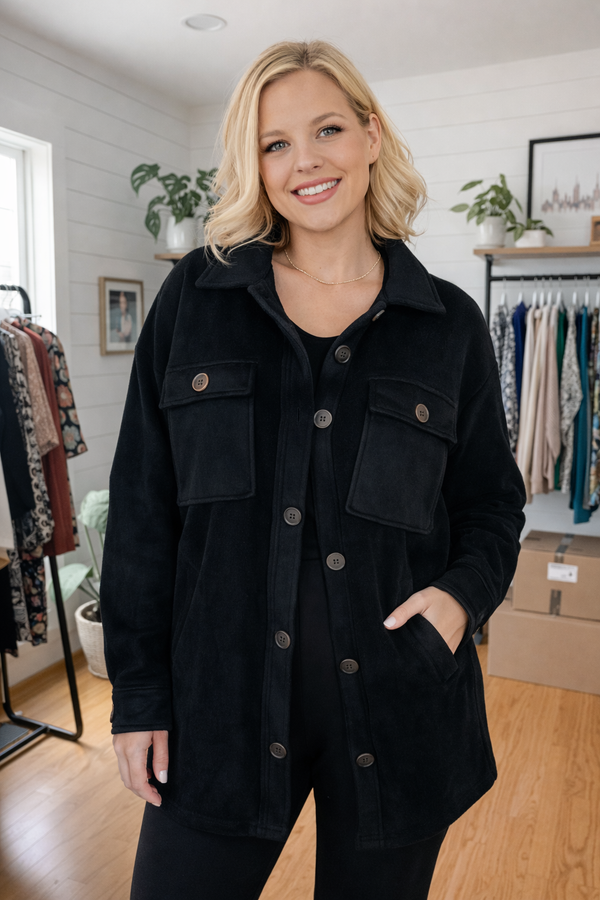 Woman wearing a black jacket in a clothing store