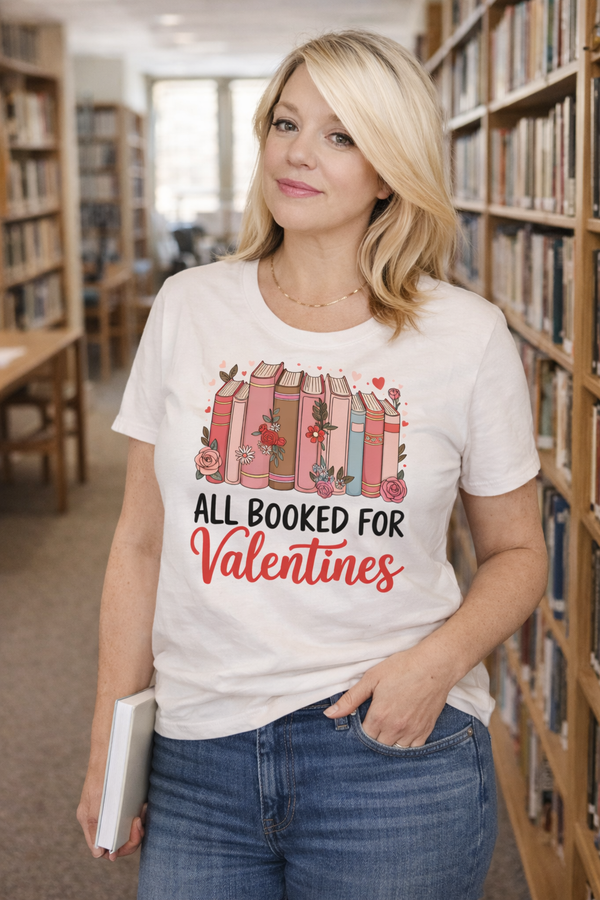 Woman wearing a 'All Booked for Valentines' t-shirt in a library.