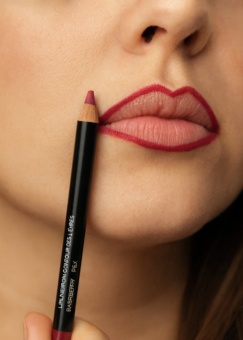 Lip liner pencil being used on lips with a blurred background