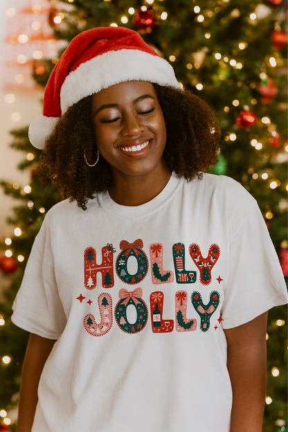 Person wearing a 'Holly Jolly' shirt with a Christmas tree in the background