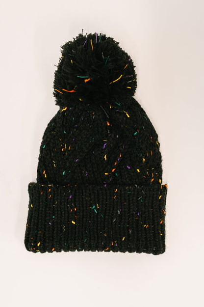 Black knit beanie with colorful speckles on a white background