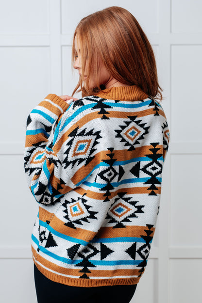 Person wearing a patterned sweater with a white tiled wall background