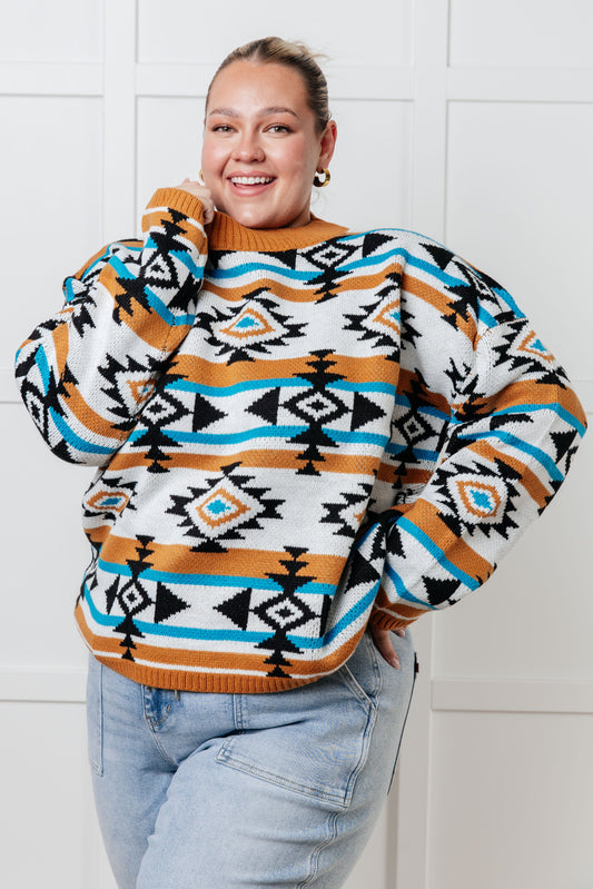 Person wearing a patterned sweater with a white tiled background