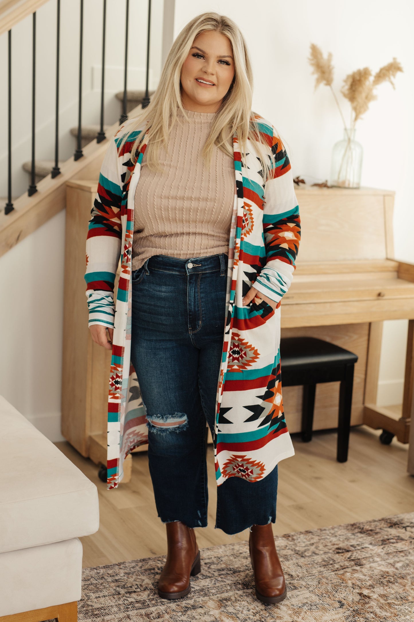 Woman wearing a colorful patterned cardigan in a home setting