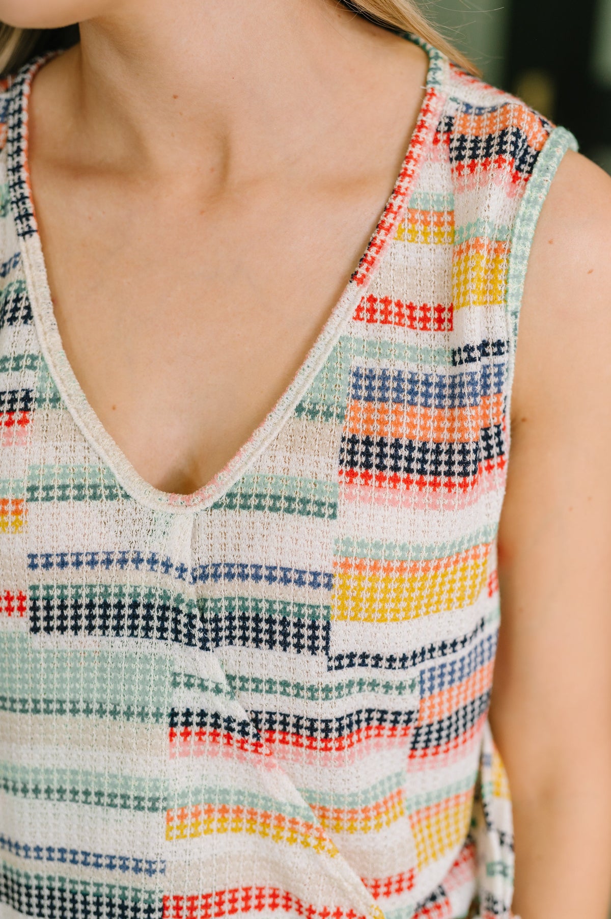 Multicolored patterned sleeveless top worn by a person