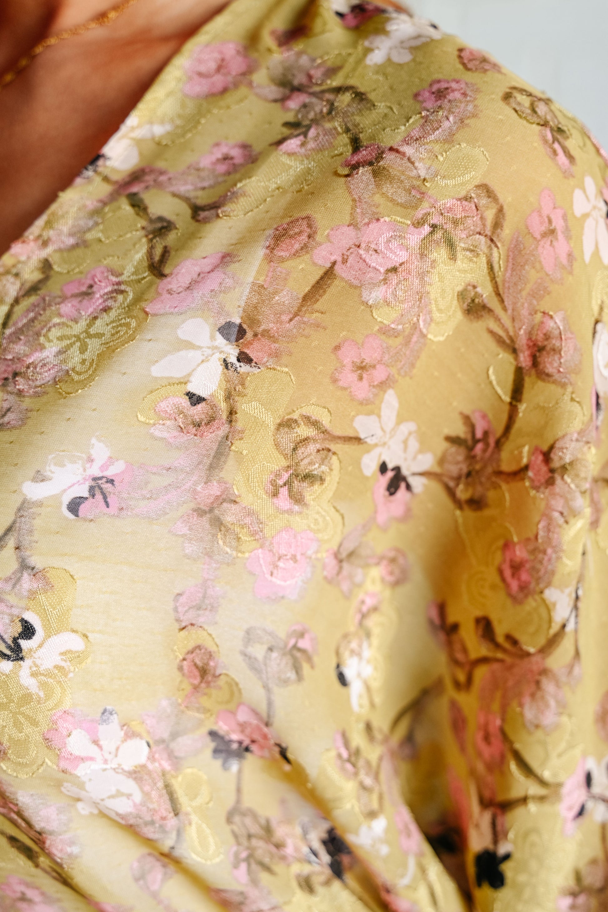 Close-up of a yellow fabric with floral pattern